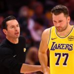 Oct 14, 2025; Phoenix, Arizona, USA; Los Angeles Lakers guard Luka Doncic (77) with head coach JJ Redick against the Phoenix Suns during an NBA preseason game at Mortgage Matchup Center. Mandatory Credit: Mark J. Rebilas-Imagn Images