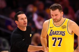 Oct 14, 2025; Phoenix, Arizona, USA; Los Angeles Lakers guard Luka Doncic (77) with head coach JJ Redick against the Phoenix Suns during an NBA preseason game at Mortgage Matchup Center. Mandatory Credit: Mark J. Rebilas-Imagn Images