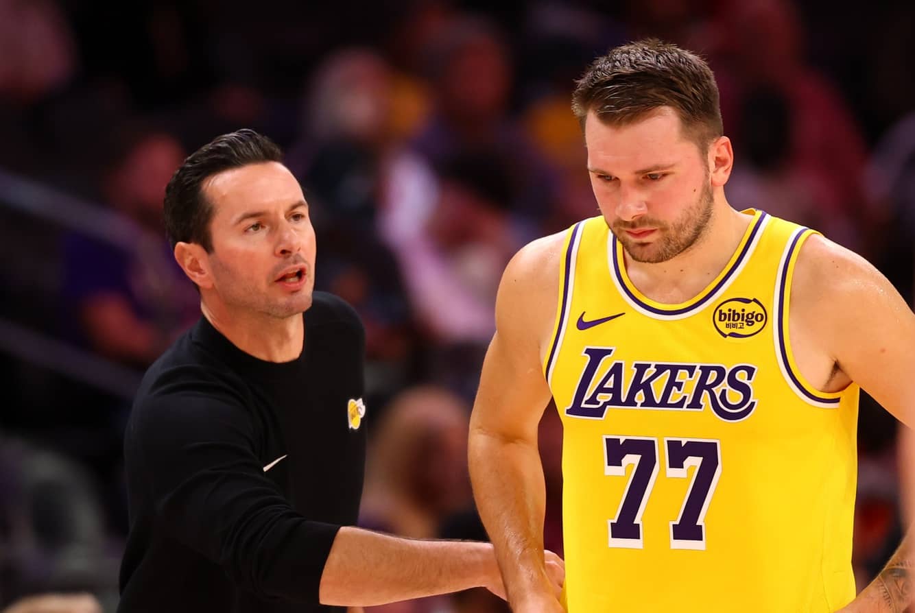 Oct 14, 2025; Phoenix, Arizona, USA; Los Angeles Lakers guard Luka Doncic (77) with head coach JJ Redick against the Phoenix Suns during an NBA preseason game at Mortgage Matchup Center. Mandatory Credit: Mark J. Rebilas-Imagn Images