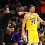Oct 14, 2025; Phoenix, Arizona, USA; Los Angeles Lakers guard Luka Doncic (77) with head coach JJ Redick against the Phoenix Suns during an NBA preseason game at Mortgage Matchup Center. Mandatory Credit: Mark J. Rebilas-Imagn Images
