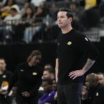 Oct 15, 2025; Las Vegas, Nevada, USA; Los Angeles Lakers head coach JJ Redick watches from the bench during the first half against the Dallas Mavericks at T-Mobile Arena. Mandatory Credit: Lucas Peltier-Imagn Images