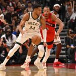 Oct 24, 2025; Toronto, Ontario, CAN; Milwaukee Bucks forward Giannis Antetokounmpo (34) is defended by Toronto Raptors forward Scottie Barnes (4) in the fourth quarter at Scotiabank Arena. Mandatory Credit: Gerry Angus-Imagn Images