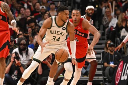Oct 24, 2025; Toronto, Ontario, CAN; Milwaukee Bucks forward Giannis Antetokounmpo (34) is defended by Toronto Raptors forward Scottie Barnes (4) in the fourth quarter at Scotiabank Arena. Mandatory Credit: Gerry Angus-Imagn Images