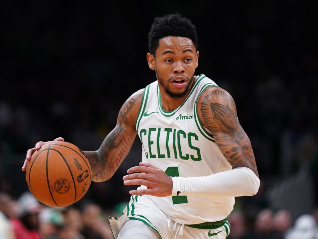 Boston Celtics guard Anfernee Simons (4) drives the ball against the Washington Wizards in the second half at TD Garden. Mandatory Credit: David Butler II-Imagn Images