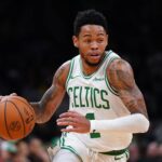 Boston Celtics guard Anfernee Simons (4) drives the ball against the Washington Wizards in the second half at TD Garden. Mandatory Credit: David Butler II-Imagn Images