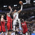 Nov 9, 2025; Milwaukee, Wisconsin, USA; Milwaukee Bucks forward Giannis Antetokounmpo (34) drives to the basket against Houston Rockets center Steven Adams (12) and Houston Rockets forward Kevin Durant (7) in the second half at Fiserv Forum. Mandatory Credit: Michael McLoone-Imagn Images