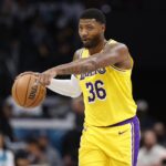 Nov 10, 2025; Charlotte, North Carolina, USA; Los Angeles Lakers guard Marcus Smart (36) directs the offense during the second quarter against the Charlotte Hornets at Spectrum Center. Mandatory Credit: Brian Westerholt-Imagn Images