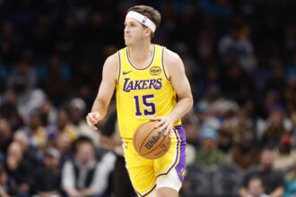 Nov 10, 2025; Charlotte, North Carolina, USA; Los Angeles Lakers guard Austin Reaves (15) brings the ball up the court during the second quarter against the Charlotte Hornets at Spectrum Center. Mandatory Credit: Brian Westerholt-Imagn Images