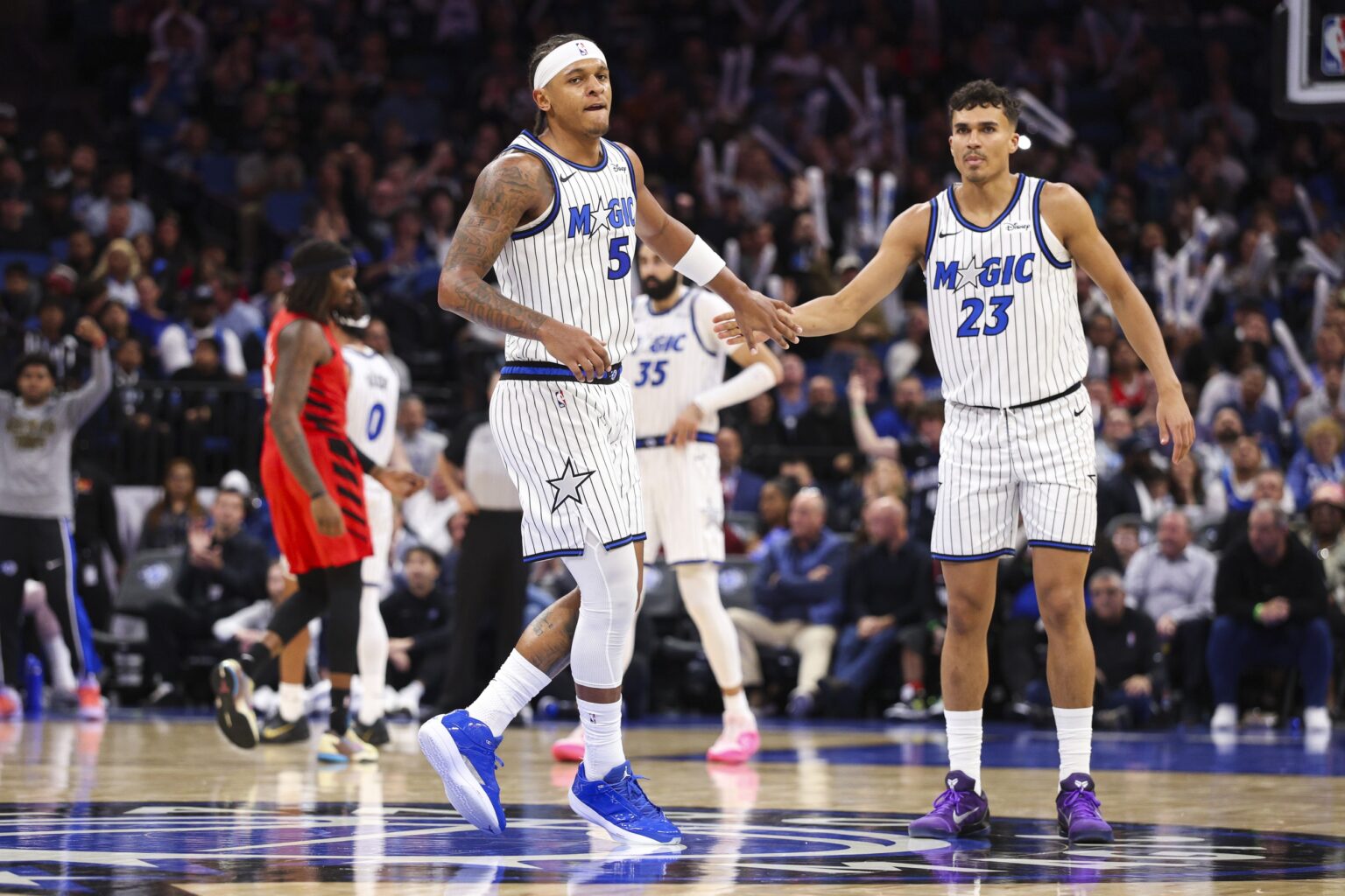 Nov 10, 2025; Orlando, Florida, USA; Orlando Magic forward Paolo Banchero (5) and forward Tristan da Silva (23) react after a play against the Portland Trail Blazers in the third quarter at Kia Center. Mandatory Credit: Nathan Ray Seebeck-Imagn Images