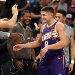 Nov 10, 2025; Phoenix, Arizona, USA; Phoenix Suns guard Grayson Allen (8) celebrates with teammates after being pulled from the game after setting the franchise record for three pointers in a game against the New Orleans Pelicans in the second half at the Mortgage Matchup Center. Mandatory Credit: Mark J. Rebilas-Imagn Images