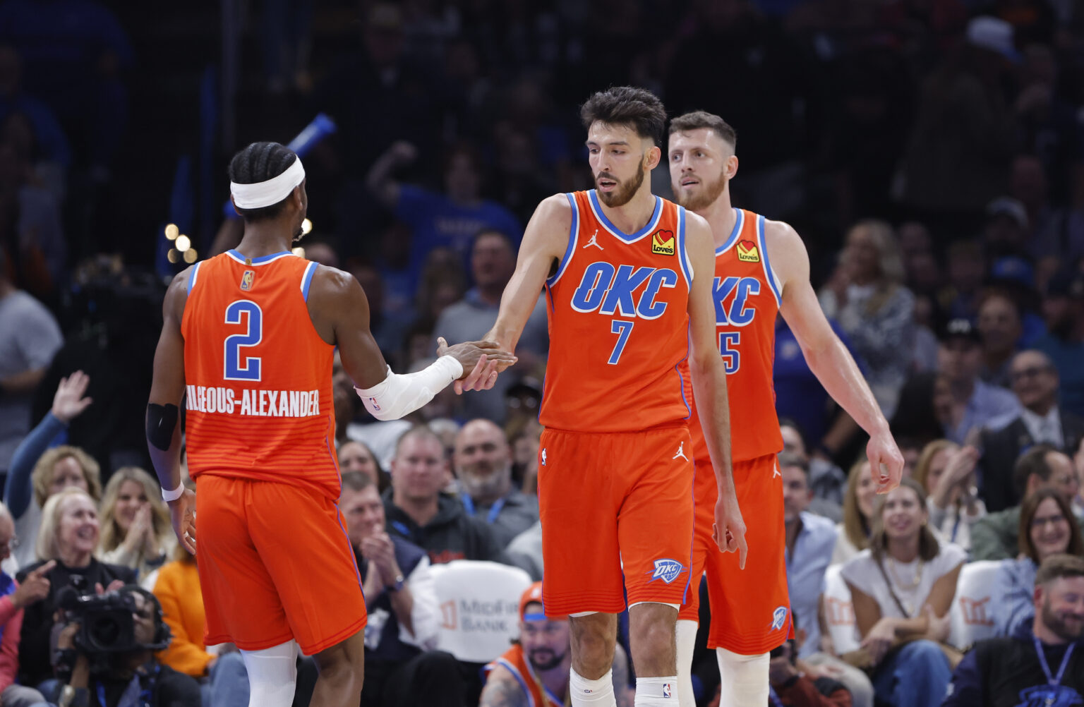 Nov 11, 2025; Oklahoma City, Oklahoma, USA; Oklahoma City Thunder center Chet Holmgren (7) and Oklahoma City Thunder guard Shai Gilgeous-Alexander (2) celebrate after scoring against the Golden State Warriors during the second half at Paycom Center. Mandatory Credit: Alonzo Adams-Imagn Images
