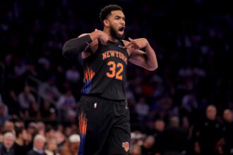 Nov 14, 2025; New York, New York, USA; New York Knicks center Karl-Anthony Towns (32) reacts during the first quarter against the Miami Heat at Madison Square Garden. Mandatory Credit: Brad Penner-Imagn Images