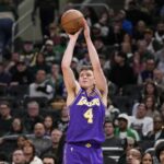 Nov 15, 2025; Milwaukee, Wisconsin, USA; Los Angeles Lakers guard Dalton Knecht (4) shoots during the third quarter against the Milwaukee Bucks at Fiserv Forum. Mandatory Credit: Jeff Hanisch-Imagn Images