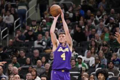 Nov 15, 2025; Milwaukee, Wisconsin, USA; Los Angeles Lakers guard Dalton Knecht (4) shoots during the third quarter against the Milwaukee Bucks at Fiserv Forum. Mandatory Credit: Jeff Hanisch-Imagn Images