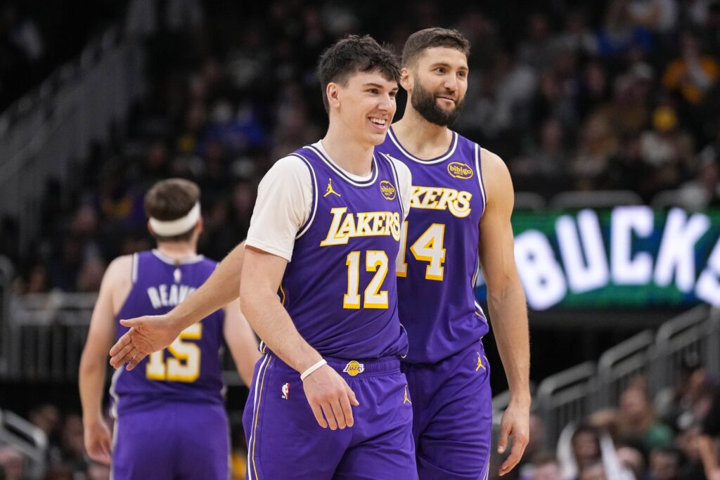 Nov 15, 2025; Milwaukee, Wisconsin, USA; Los Angeles Lakers forward Jake LaRavia (12) and center Maxi Kleber (14) enjoy a moment during the fourth quarter against the Milwaukee Bucks at Fiserv Forum. Mandatory Credit: Jeff Hanisch-Imagn Images