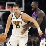Nov 15, 2025; Minneapolis, Minnesota, USA; Denver Nuggets center Nikola Jokic (15) dribbles the ball past Minnesota Timberwolves forward Julius Randle (30) in the second half at Target Center. Mandatory Credit: Jesse Johnson-Imagn Images