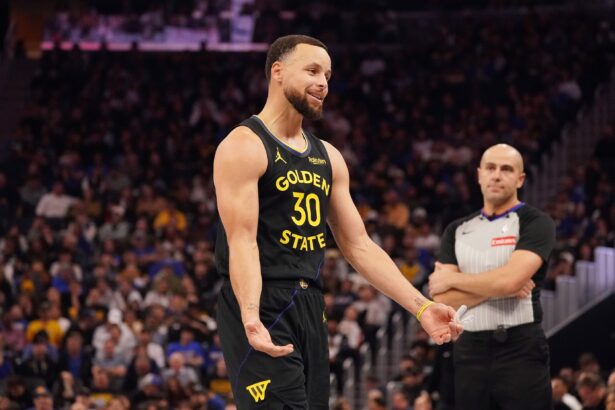 Nov 26, 2025; San Francisco, California, USA; Golden State Warriors guard Stephen Curry (30) talks to the Houston Rockets bench during a break in the action in the third quarter at Chase Center. Mandatory Credit: David Gonzales-Imagn Images