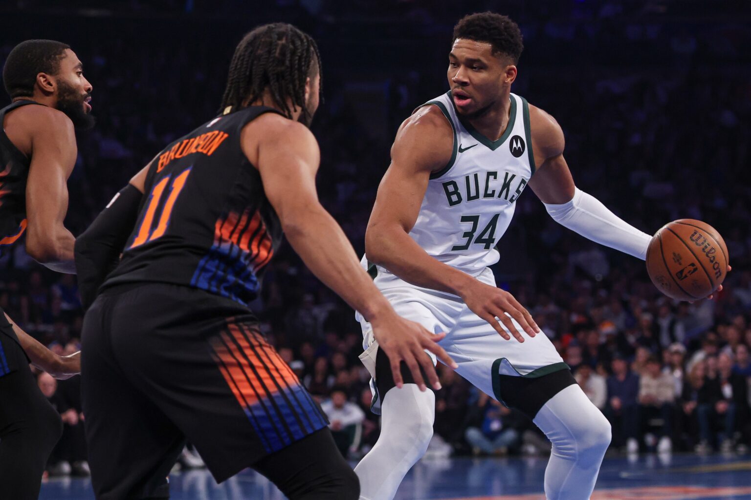 Nov 28, 2025; New York, New York, USA; Milwaukee Bucks forward Giannis Antetokounmpo (34) dribbles as New York Knicks guard Jalen Brunson (11) defends during the first half at Madison Square Garden. Mandatory Credit: Vincent Carchietta-Imagn Images