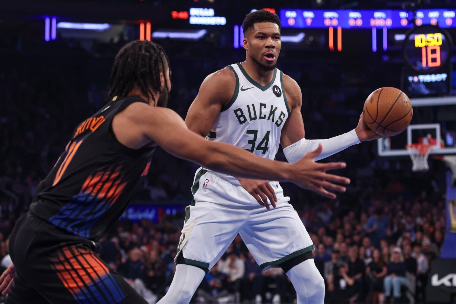 Nov 28, 2025; New York, New York, USA; Milwaukee Bucks forward Giannis Antetokounmpo (34) looks to pass as New York Knicks guard Jalen Brunson (11) defends during the first half at Madison Square Garden. Mandatory Credit: Vincent Carchietta-Imagn Images