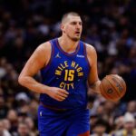 Nov 28, 2025; Denver, Colorado, USA; Denver Nuggets center Nikola Jokic (15) controls the ball in the first quarter against the San Antonio Spurs at Ball Arena. Mandatory Credit: Isaiah J. Downing-Imagn Images