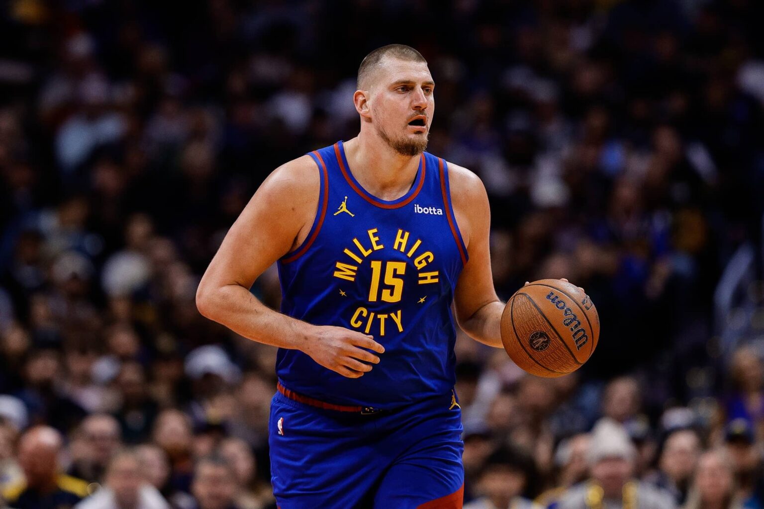 Nov 28, 2025; Denver, Colorado, USA; Denver Nuggets center Nikola Jokic (15) controls the ball in the first quarter against the San Antonio Spurs at Ball Arena. Mandatory Credit: Isaiah J. Downing-Imagn Images