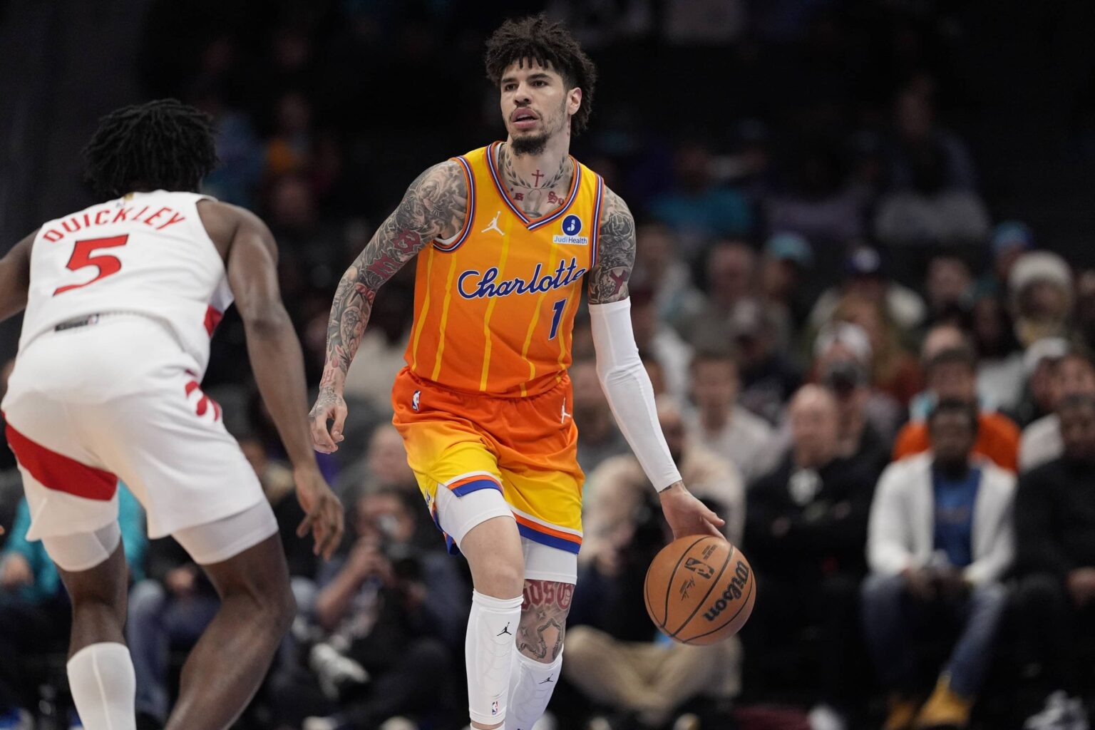 Nov 29, 2025; Charlotte, North Carolina, USA; Charlotte Hornets guard LaMelo Ball (1) brings the ball up court defended by Toronto Raptors guard Immanuel Quickley (5) during the first quarter at Spectrum Center. Mandatory Credit: Jim Dedmon-Imagn Images