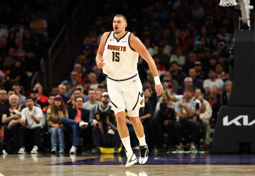 Nov 29, 2025; Phoenix, Arizona, USA; Denver Nuggets center Nikola Jokic (15) against the Phoenix Suns at the Mortgage Matchup Center. Mandatory Credit: Mark J. Rebilas-Imagn Images