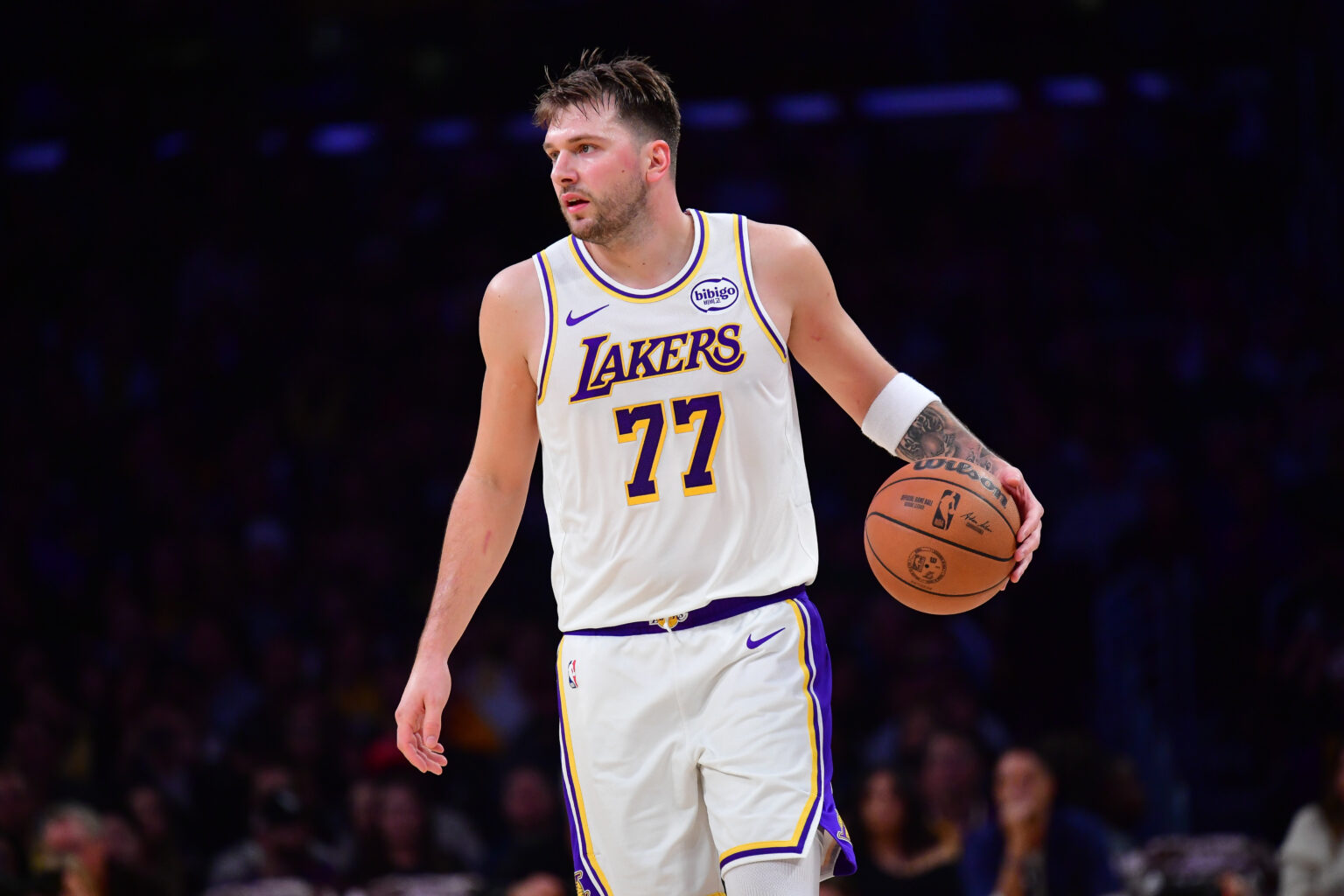 Nov 30, 2025; Los Angeles, California, USA; Los Angeles Lakers guard Luka Doncic (77) controls the ball against the New Orleans Pelicans during the first half at Crypto.com Arena. Mandatory Credit: Gary A. Vasquez-Imagn Images