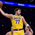 Dec 1, 2025; Los Angeles, California, USA; Los Angeles Lakers guard Luka Doncic (77) gets the rebound against the against the Phoenix Suns during the first half at Crypto.com Arena. Mandatory Credit: Gary A. Vasquez-Imagn Images