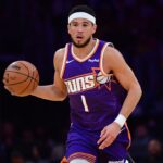 Dec 1, 2025; Los Angeles, California, USA; Phoenix Suns guard Devin Booker (1) moves the ball up court against the Los Angeles Lakers during the first half at Crypto.com Arena. Mandatory Credit: Gary A. Vasquez-Imagn Images