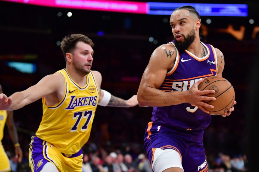Dec 1, 2025; Los Angeles, California, USA; Phoenix Suns forward Dillon Brooks (3) moves the ball against Los Angeles Lakers guard Luka Doncic (77) during the first half at Crypto.com Arena. Mandatory Credit: Gary A. Vasquez-Imagn Images