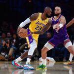 Dec 1, 2025; Los Angeles, California, USA; Los Angeles Lakers forward LeBron James (23) moves the ball against Phoenix Suns forward Dillon Brooks (3) during the first half at Crypto.com Arena. Mandatory Credit: Gary A. Vasquez-Imagn Images