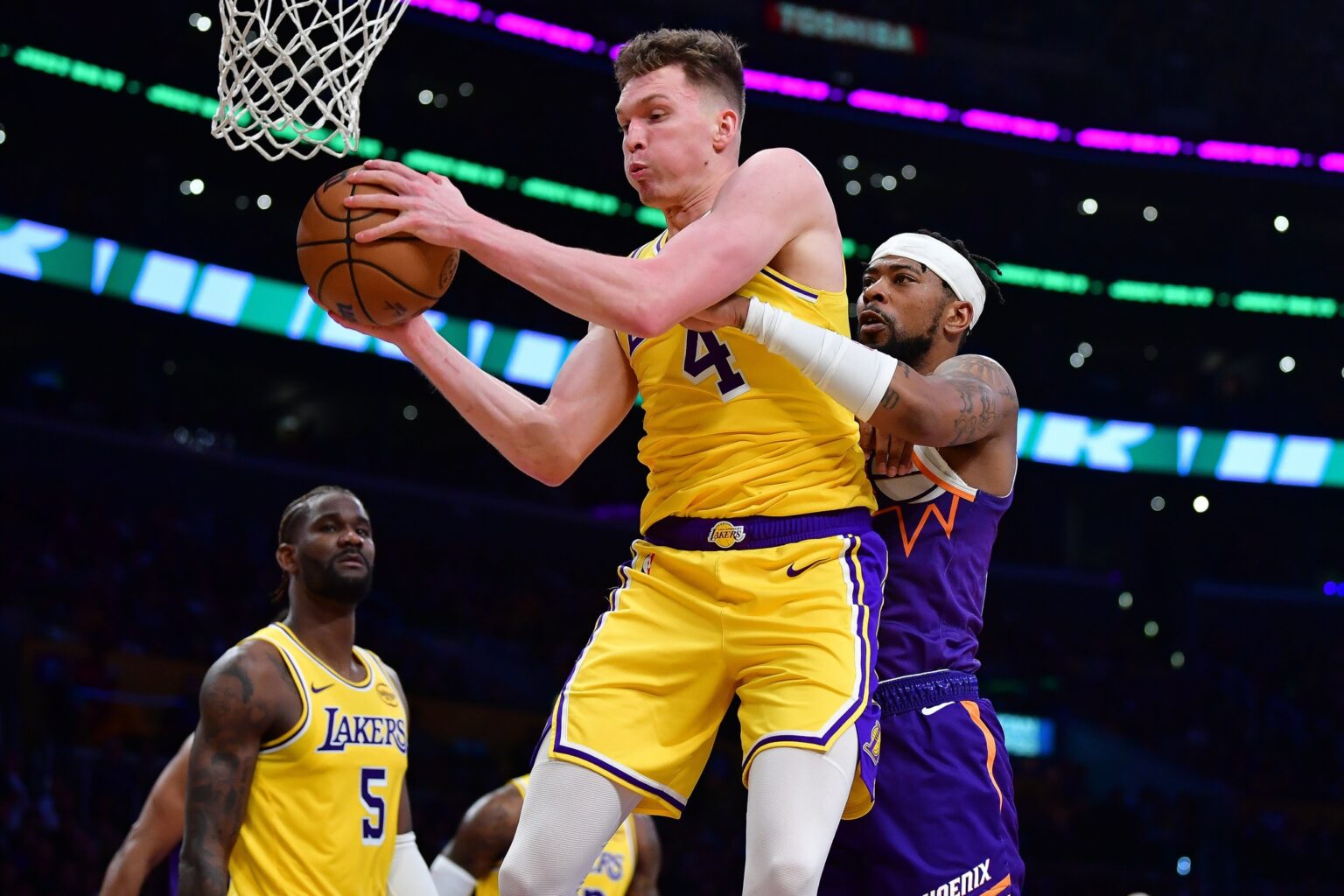 Dec 1, 2025; Los Angeles, California, USA; Los Angeles Lakers forward Dalton Knecht (4) gets the rebound against Phoenix Suns guard Jordan Goodwin (23) during the first half at Crypto.com Arena. Mandatory Credit: Gary A. Vasquez-Imagn Images