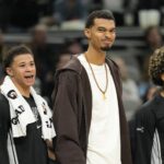 Dec 2, 2025; San Antonio, Texas, USA; San Antonio Spurs forward Victor Wembanyama (1) along with forward Carter Bryant (11) react from the bench during the second half against the Memphis Grizzlies at Frost Bank Center. Mandatory Credit: Scott Wachter-Imagn Images