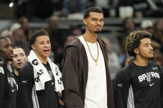 Dec 2, 2025; San Antonio, Texas, USA; San Antonio Spurs forward Victor Wembanyama (1) along with forward Carter Bryant (11) react from the bench during the second half against the Memphis Grizzlies at Frost Bank Center. Mandatory Credit: Scott Wachter-Imagn Images
