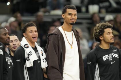 Dec 2, 2025; San Antonio, Texas, USA; San Antonio Spurs forward Victor Wembanyama (1) along with forward Carter Bryant (11) react from the bench during the second half against the Memphis Grizzlies at Frost Bank Center. Mandatory Credit: Scott Wachter-Imagn Images