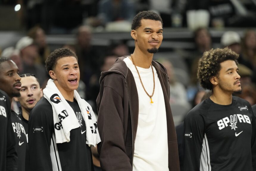 Dec 2, 2025; San Antonio, Texas, USA; San Antonio Spurs forward Victor Wembanyama (1) along with forward Carter Bryant (11) react from the bench during the second half against the Memphis Grizzlies at Frost Bank Center. Mandatory Credit: Scott Wachter-Imagn Images
