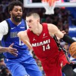 Dec 3, 2025; Dallas, Texas, USA; Miami Heat guard Tyler Herro (14) dribbles as Dallas Mavericks forward Naji Marshall (13) defends during the second half at American Airlines Center. Mandatory Credit: Kevin Jairaj-Imagn Images