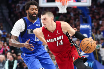 Dec 3, 2025; Dallas, Texas, USA; Miami Heat guard Tyler Herro (14) dribbles as Dallas Mavericks forward Naji Marshall (13) defends during the second half at American Airlines Center. Mandatory Credit: Kevin Jairaj-Imagn Images