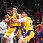 Dec 4, 2025; Toronto, Ontario, CAN; Los Angeles Lakers forward Rui Hachimura (28) celebrates with forward Jake LaRavia (12) and guard Austin Reaves (15) after scoring the game winning buzzer beating basket against the Toronto Raptos half at Scotiabank Arena. Mandatory Credit: Dan Hamilton-Imagn Images