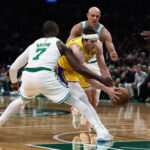 Dec 5, 2025; Boston, Massachusetts, USA; Los Angeles Lakers guard Austin Reaves (15) tries to get past Boston Celtics guard Jaylen Brown (7) during the first quarter at TD Garden. Mandatory Credit: Winslow Townson-Imagn Images