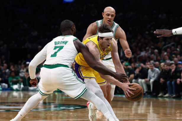 Dec 5, 2025; Boston, Massachusetts, USA; Los Angeles Lakers guard Austin Reaves (15) tries to get past Boston Celtics guard Jaylen Brown (7) during the first quarter at TD Garden. Mandatory Credit: Winslow Townson-Imagn Images