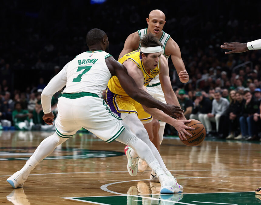 Dec 5, 2025; Boston, Massachusetts, USA; Los Angeles Lakers guard Austin Reaves (15) tries to get past Boston Celtics guard Jaylen Brown (7) during the first quarter at TD Garden. Mandatory Credit: Winslow Townson-Imagn Images