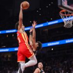 Dec 5, 2025; Atlanta, Georgia, USA; Atlanta Hawks forward Jalen Johnson (1) dunks over Denver Nuggets guard Jamal Murray (27) in the second quarter at State Farm Arena. Mandatory Credit: Brett Davis-Imagn Images