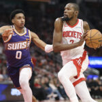 Dec 5, 2025; Houston, Texas, USA; Houston Rockets forward Kevin Durant (7) drives witht the ball as Phoenix Suns forward Ryan Dunn (0) defends during the second quarter at Toyota Center. Mandatory Credit: Troy Taormina-Imagn Images