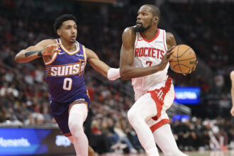 Dec 5, 2025; Houston, Texas, USA; Houston Rockets forward Kevin Durant (7) drives witht the ball as Phoenix Suns forward Ryan Dunn (0) defends during the second quarter at Toyota Center. Mandatory Credit: Troy Taormina-Imagn Images
