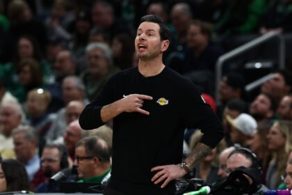 Dec 5, 2025; Boston, Massachusetts, USA; Los Angeles Lakers head coach JJ Redick signals to his players during the first half against the Boston Celtics at TD Garden. Mandatory Credit: Winslow Townson-Imagn Images