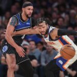 Dec 7, 2025; New York, New York, USA; Orlando Magic guard Jalen Suggs (4) knocks the ball away from New York Knicks guard Jalen Brunson (11) in the fourth quarter at Madison Square Garden. Mandatory Credit: Wendell Cruz-Imagn Images