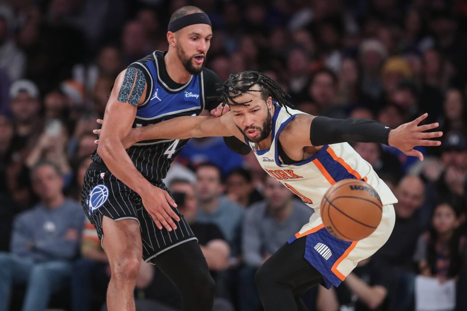 Dec 7, 2025; New York, New York, USA; Orlando Magic guard Jalen Suggs (4) knocks the ball away from New York Knicks guard Jalen Brunson (11) in the fourth quarter at Madison Square Garden. Mandatory Credit: Wendell Cruz-Imagn Images