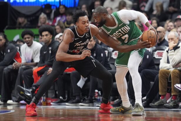 Dec 7, 2025; Toronto, Ontario, CAN; Boston Celtics forward Jaylen Brown (7) controls the ball against Toronto Raptors guard Scottie Barnes (4) during the second half at Scotiabank Arena. Mandatory Credit: John E. Sokolowski-Imagn Images